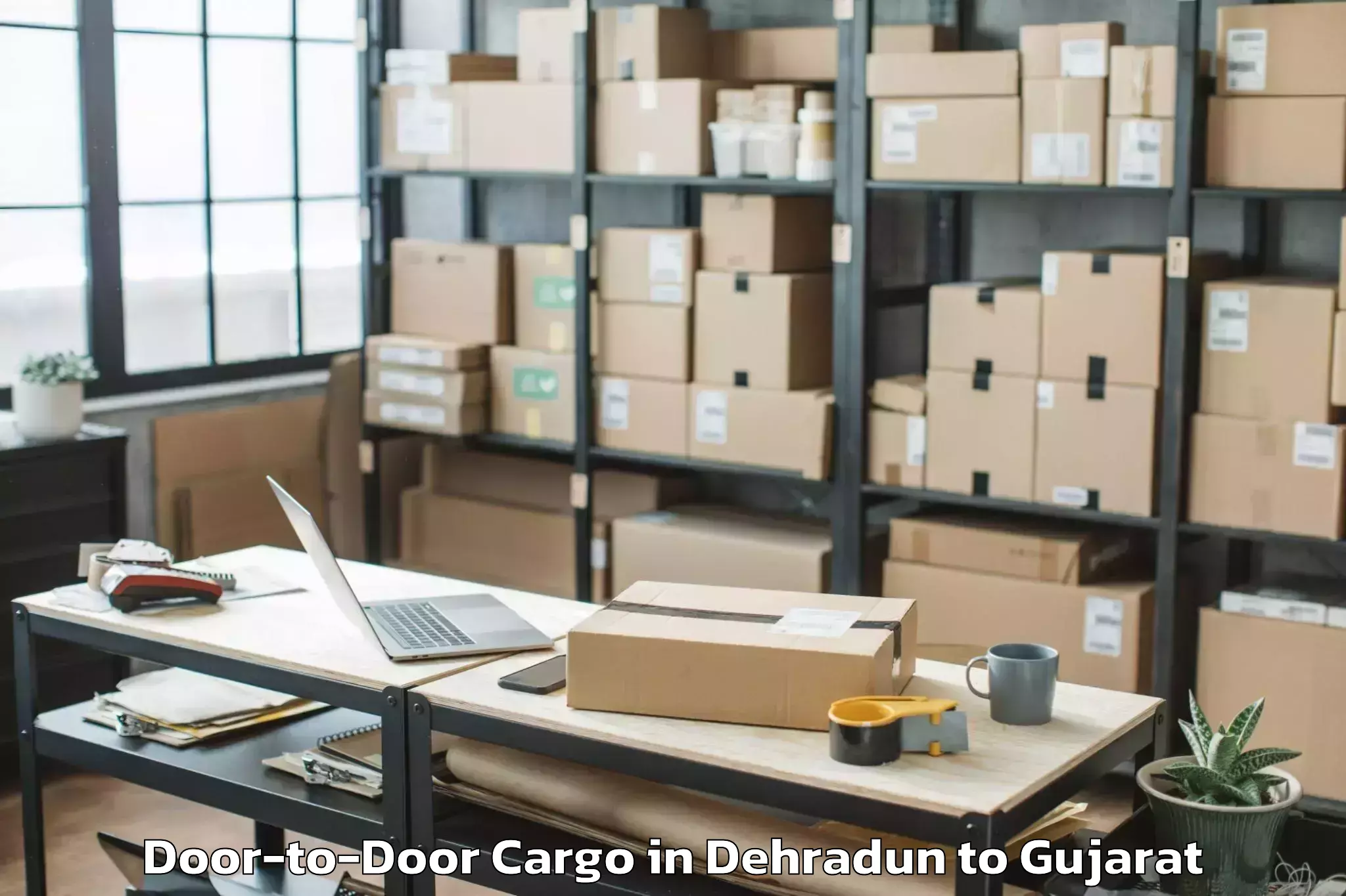 Top Dehradun to Khambhaliya Door To Door Cargo Available